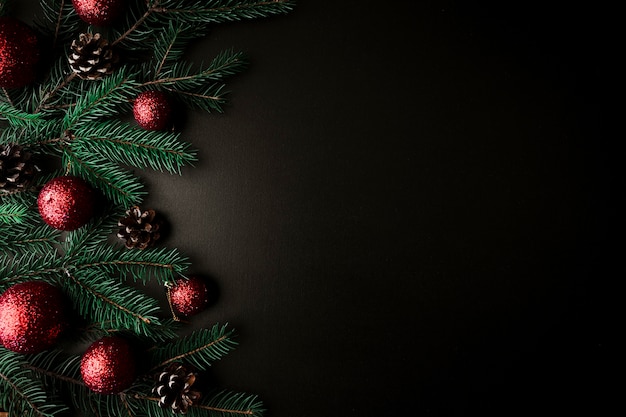 Christmas composition of fir tree branches with red baubles