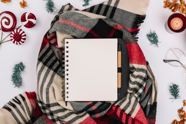 Christmas composition of notepad on scarf