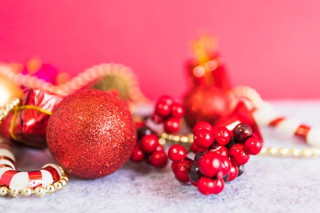 Christmas composition of red bauble with berries 