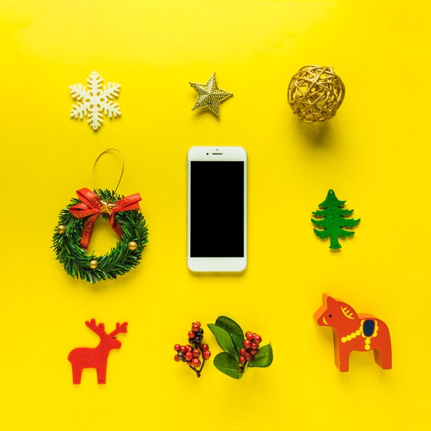 Christmas composition of smartphone with toys 