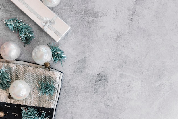 Christmas composition of white baubles with green branches