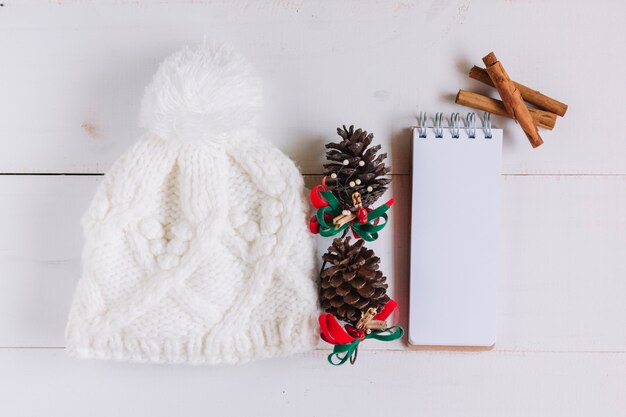 Christmas composition of white hat with cones 