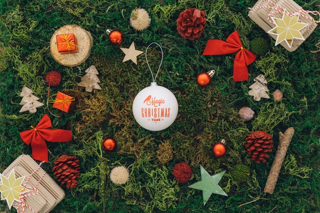 Christmas composition with ball on grass