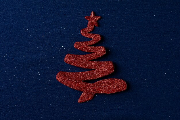 Christmas composition with red christmas tree decorations on blue background. copy space.