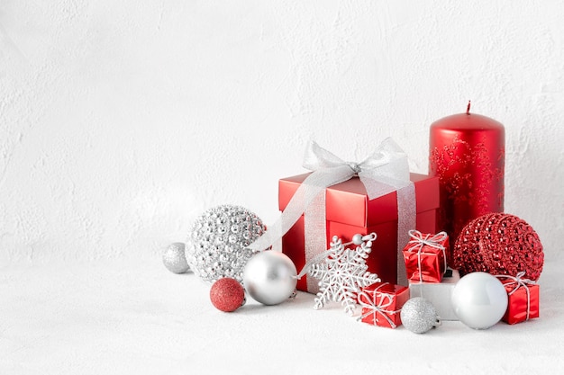 Christmas composition with red and white gifts on white background
