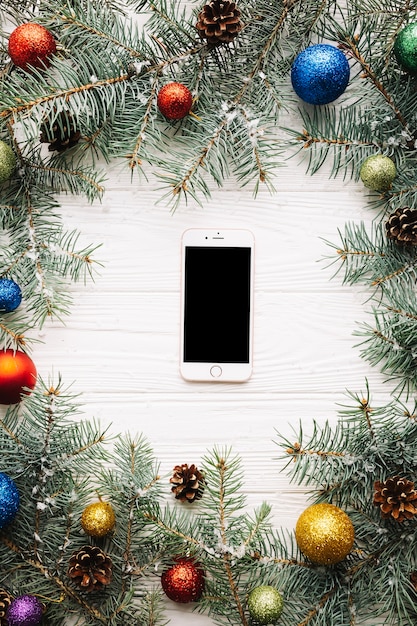Christmas composition with smartphone in middle