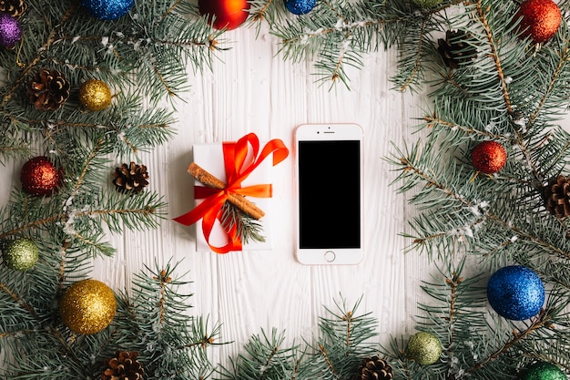 Christmas composition with smartphone and present