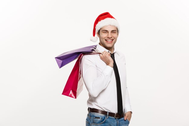 Christmas Concept Handsome Business man celebrate merry christmas and happy new year wear santa hat with Santa red big bag