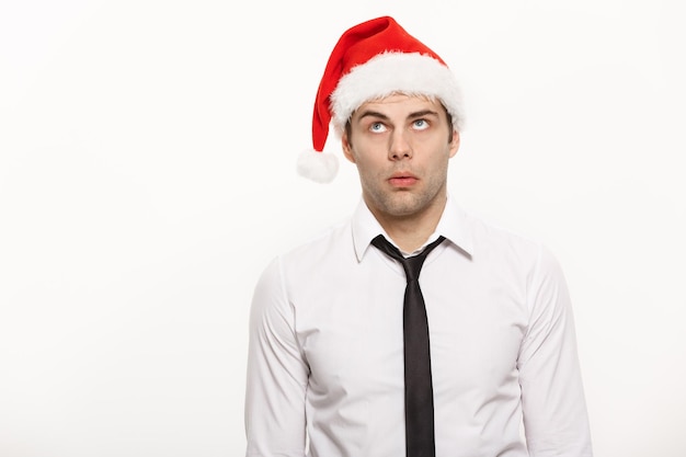 Christmas Concept Handsome Business man wear santa hat posing with thoughtful facial expression on white isolated background