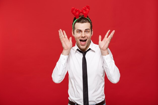 Christmas Concept portrait happy Santa christmas businessman exciting and surprising facial expression over red background