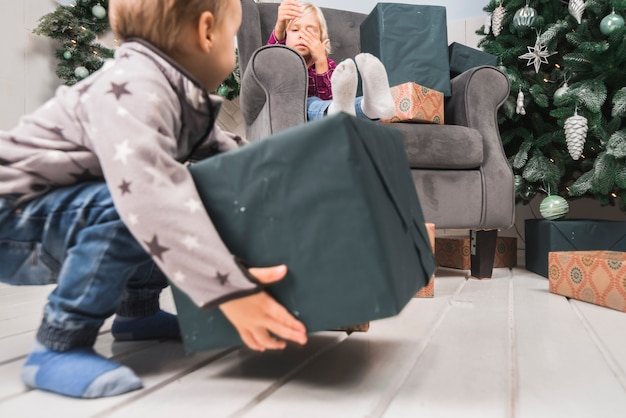 Рождественская концепция с ребенком, проведение подарочной коробке