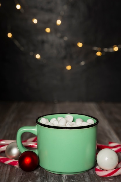 Christmas concept with marshmallow drink and lights