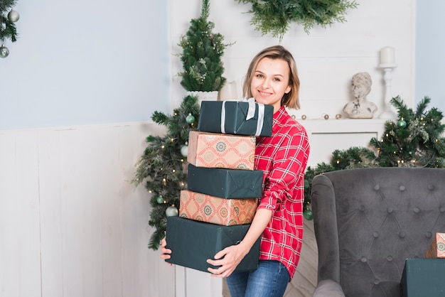Christmas concept with mother carrying gift boxes