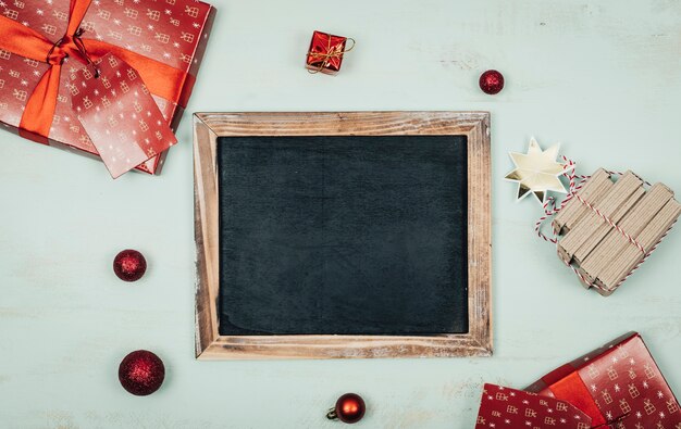 Christmas concept with slate and gifts