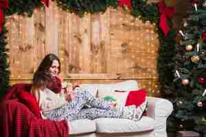 Free photo christmas concept with woman on couch