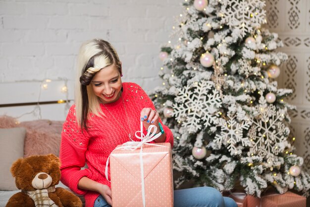 Christmas concept with woman opening gift