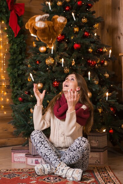 Christmas concept with woman throwing teddy bear