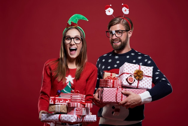 Christmas couple carrying heavy presents