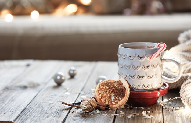 Christmas cup with hot drink on blurred background with bokeh.