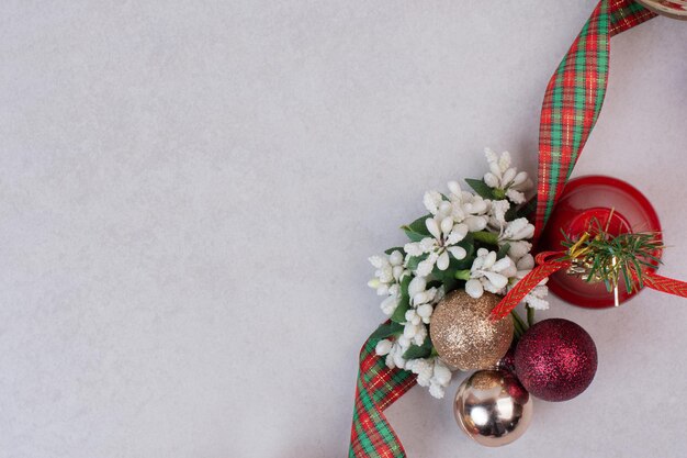 Christmas decoration balls with band on white table .