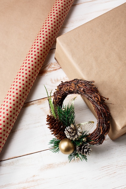 Free photo christmas decoration and gift box over wooden table