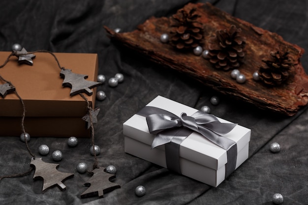 Christmas decoration and gift boxes over grey background.