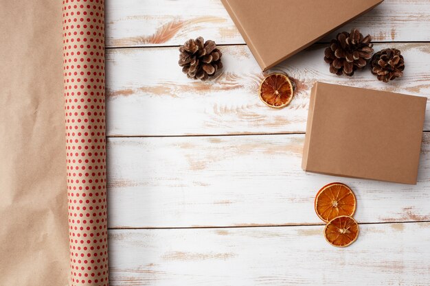 Christmas decoration and gift boxes over wooden background. Above.