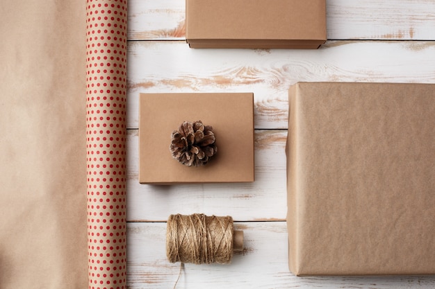 Christmas decoration and gift boxes over wooden background. Above.