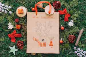 Free photo christmas decoration on grass with bag