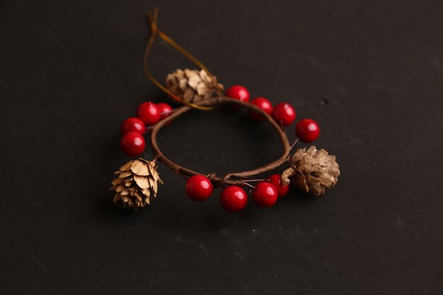 Christmas decoration with pine cones and red ball isolated on black