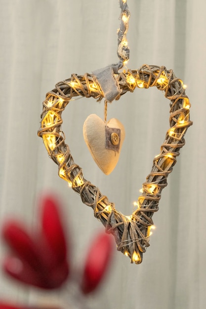 Christmas decoration with the shape of a heart made of branches and lights