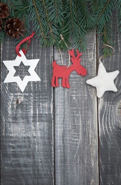 Christmas decorations hanging on branch of pine tree