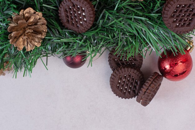 Christmas decorations with cookies on white surface