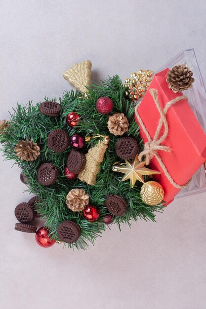 Christmas decorations with cookies on white table.