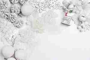 Free photo christmas decorative composition of toys on a white table background. top view. flat lay