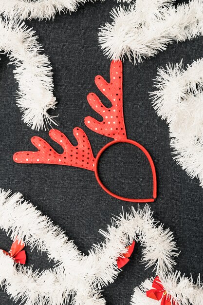 Christmas deer horns with tinsel on table