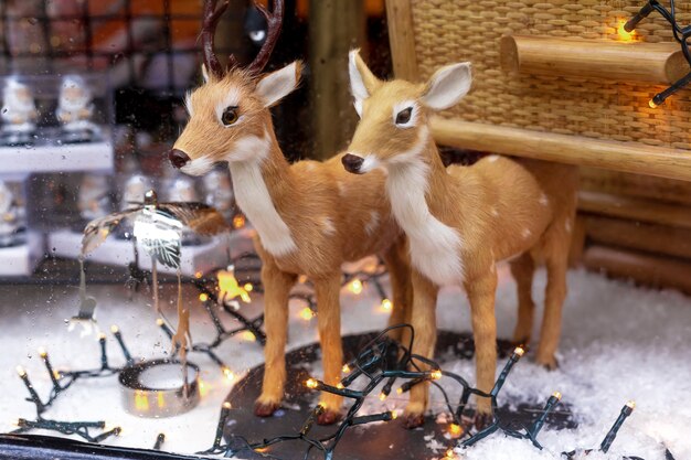 Christmas deer and reindeer. new year decor toys outside the window on rainy day.