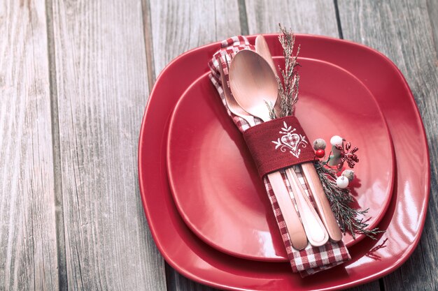 Christmas dinner cutlery with decor on a wooden background