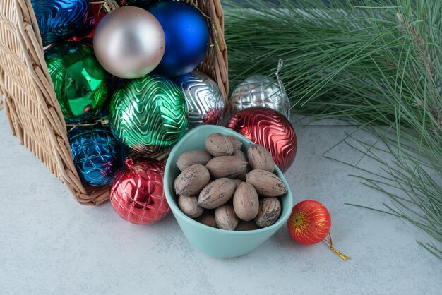Christmas festive balls with a blue plate of nuts. High quality photo