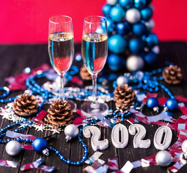 Christmas, festive mood: glass of champagne and New Year's 2020 decoration