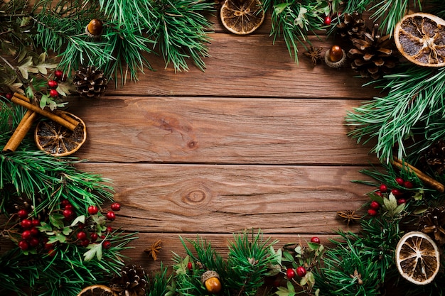 Christmas fir branches on wooden board