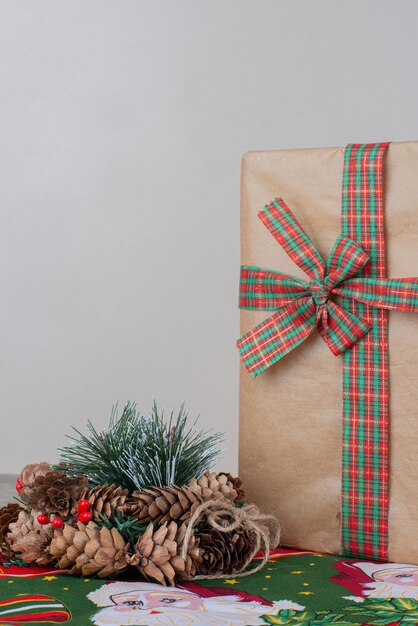 Christmas gift box and wreath on marble.