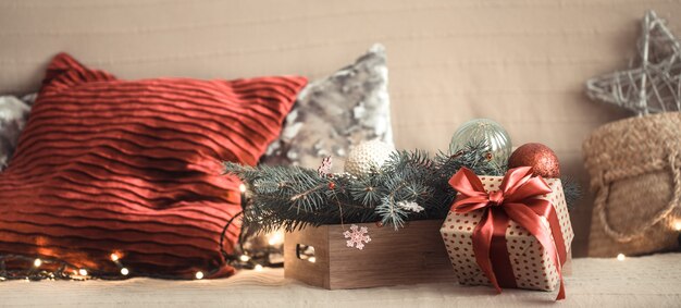 Christmas gift in the living room on the sofa, with festive decor items.