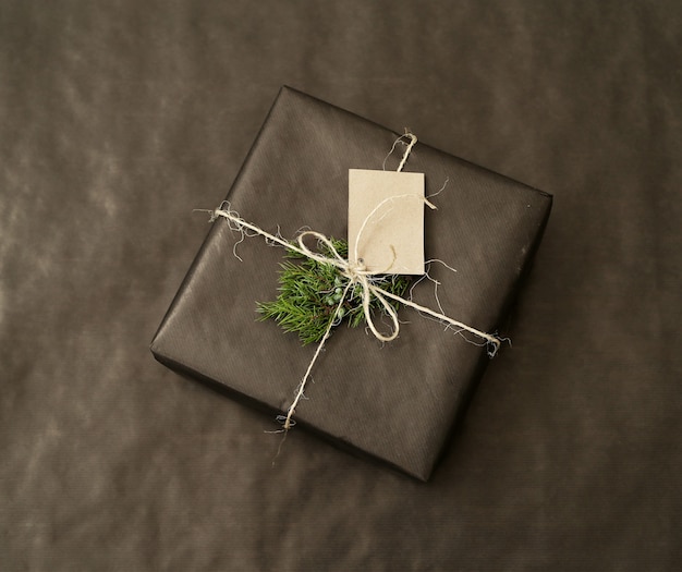 Free photo christmas gift with black wrapped paper