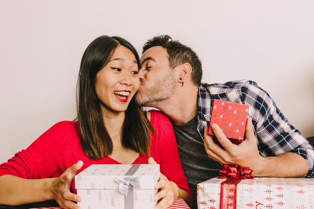 Christmas gifting concept with man kissing woman