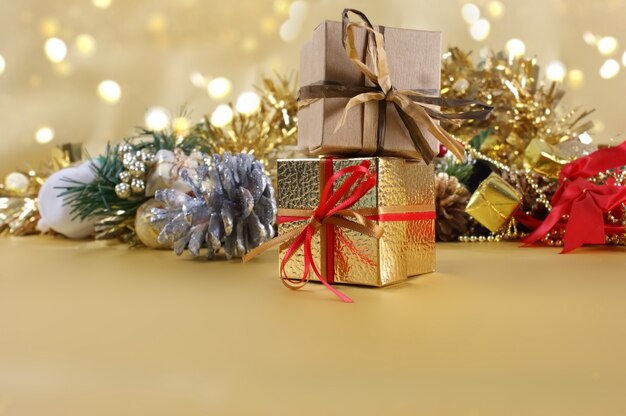 Christmas gifts and decorations on gold background
