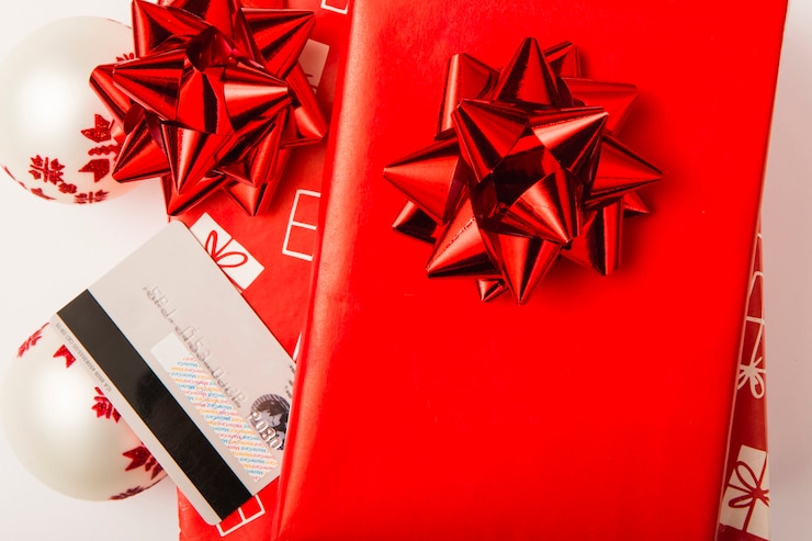 Free Photo christmas gifts with red bows and credit card