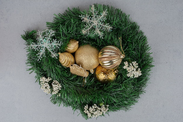 Christmas golden ball on green tinsel. 