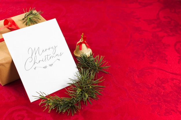 Christmas greeting card on red table