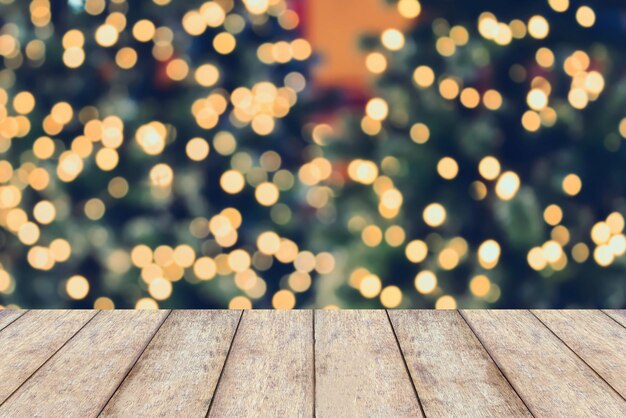 Christmas holiday background with empty wooden table top over festive bokeh light decorate on christmas tree. for create montage product display